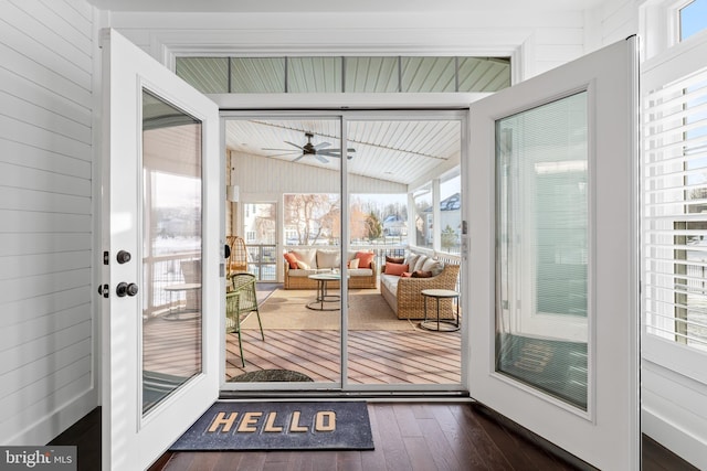 entryway with ceiling fan, vaulted ceiling, a wealth of natural light, and dark hardwood / wood-style flooring