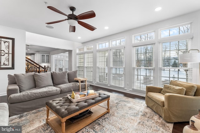 living room featuring hardwood / wood-style flooring and ceiling fan