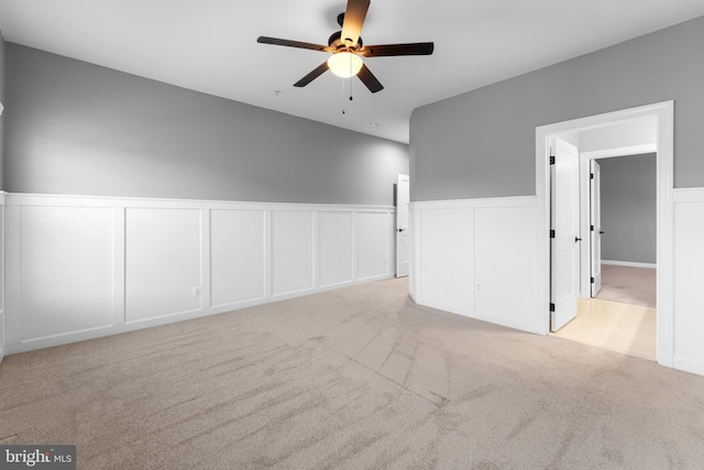 spare room with ceiling fan and light colored carpet