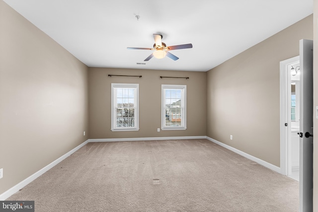 carpeted spare room with ceiling fan