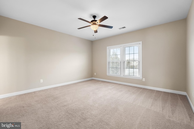 spare room with carpet flooring and ceiling fan