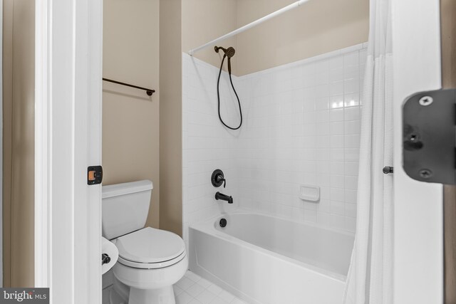 bathroom with toilet and shower / bathtub combination with curtain