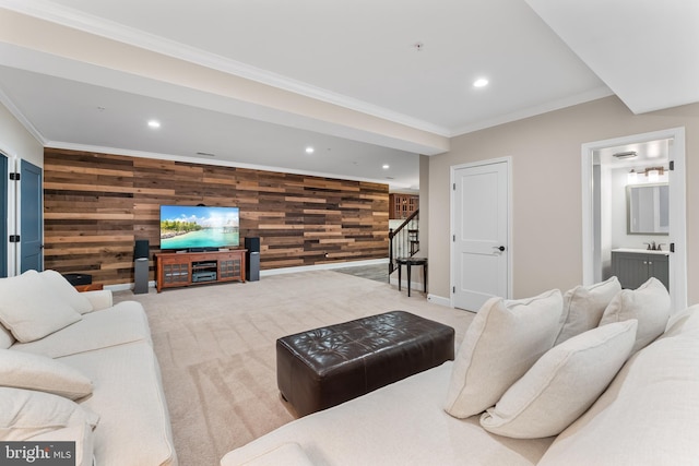 carpeted living room with crown molding, wooden walls, and a fireplace