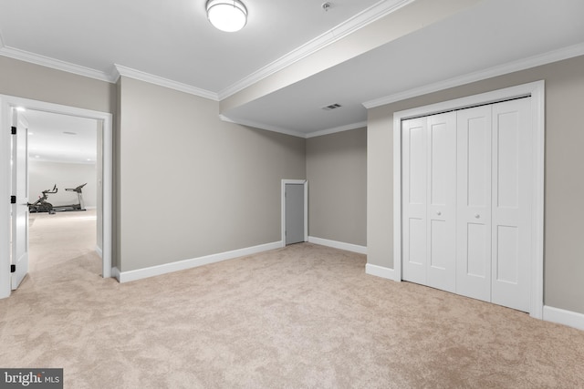 unfurnished bedroom with light colored carpet, a closet, and ornamental molding