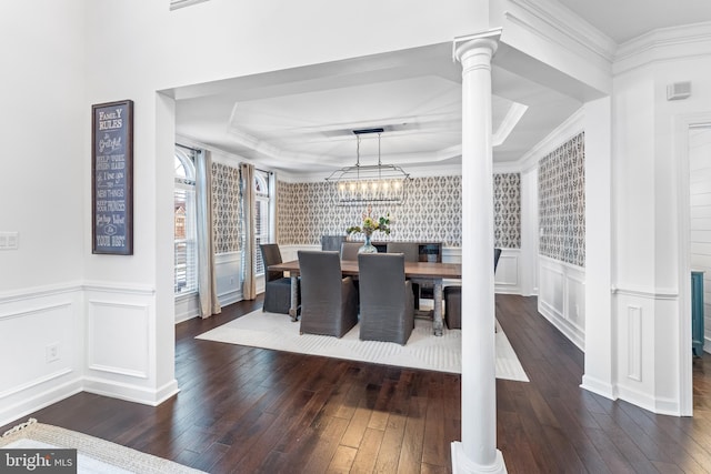 dining room featuring ornamental molding, dark hardwood / wood-style floors, and ornate columns