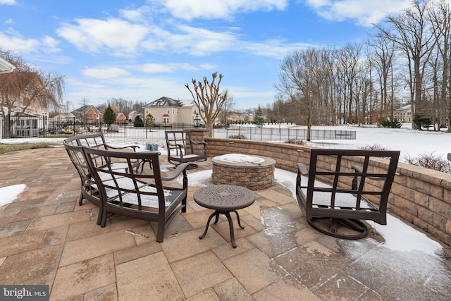 snow covered patio featuring a fire pit