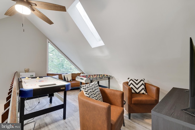 office space with ceiling fan, light wood-type flooring, and lofted ceiling with skylight