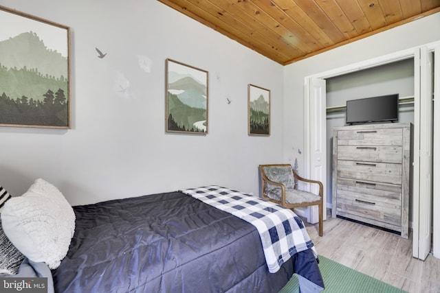 bedroom with a closet, wood ceiling, and hardwood / wood-style floors