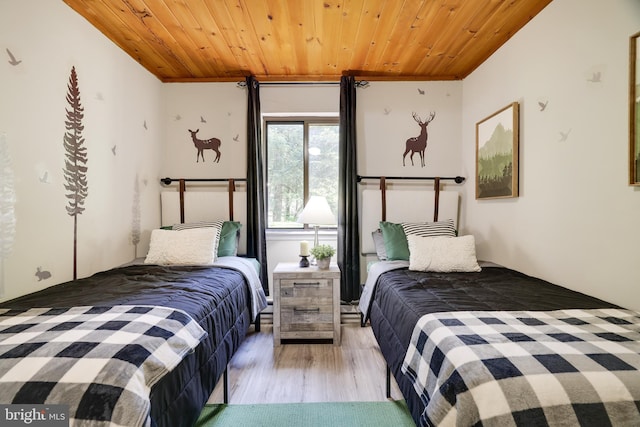 bedroom featuring light hardwood / wood-style floors and wood ceiling