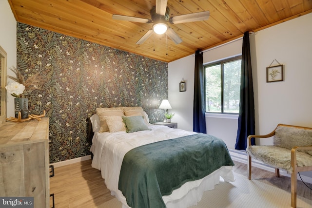 bedroom with ceiling fan, wood ceiling, and light hardwood / wood-style floors