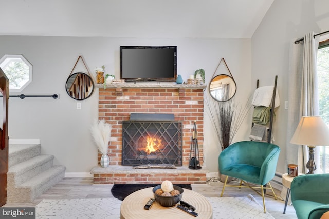 living room featuring light hardwood / wood-style flooring and a fireplace