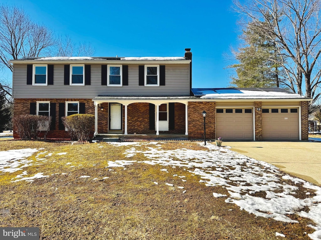 front facade featuring a garage and covered porch