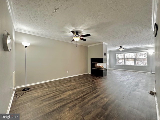 unfurnished living room featuring hardwood / wood-style flooring, a multi sided fireplace, ceiling fan, and crown molding