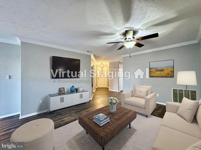 living room with dark hardwood / wood-style flooring, ornamental molding, and a textured ceiling