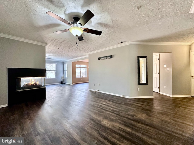 unfurnished living room with crown molding, ceiling fan, a multi sided fireplace, a textured ceiling, and dark hardwood / wood-style flooring