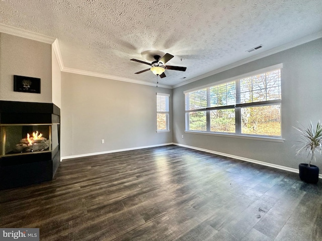 unfurnished living room with dark wood-type flooring, a textured ceiling, a multi sided fireplace, ornamental molding, and ceiling fan