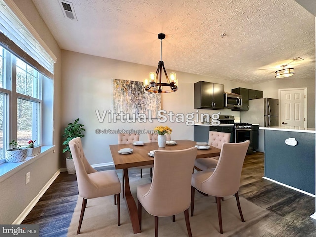 dining area featuring dark hardwood / wood-style flooring, a chandelier, and a textured ceiling