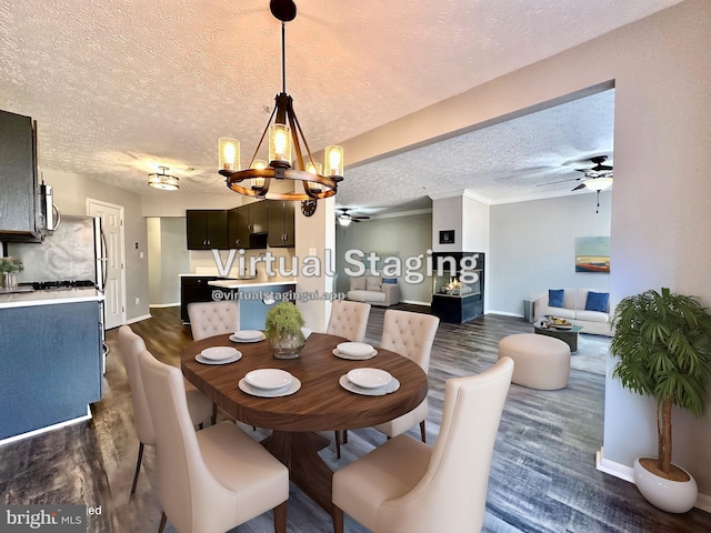 dining area with crown molding, ceiling fan with notable chandelier, a textured ceiling, and dark hardwood / wood-style flooring