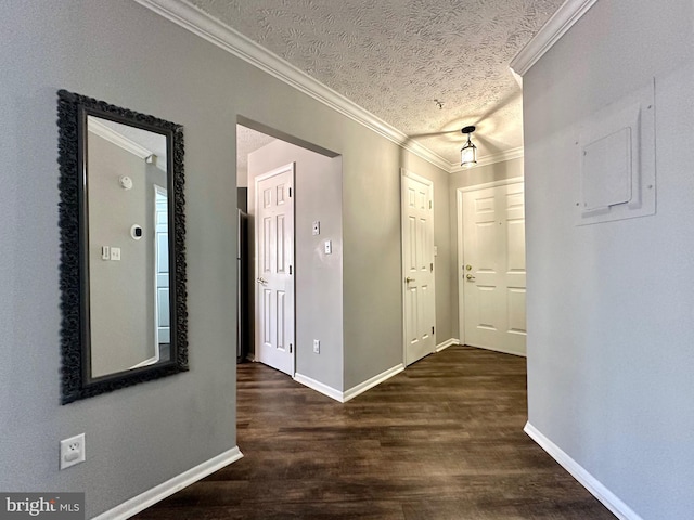 corridor featuring crown molding, dark hardwood / wood-style floors, and a textured ceiling