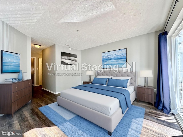 bedroom with dark hardwood / wood-style flooring and a textured ceiling