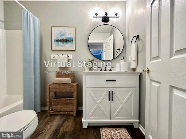 full bathroom featuring shower / bathtub combination with curtain, vanity, hardwood / wood-style flooring, and toilet