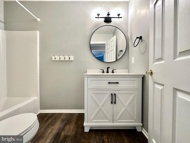 full bathroom with vanity, hardwood / wood-style flooring, bathtub / shower combination, and toilet