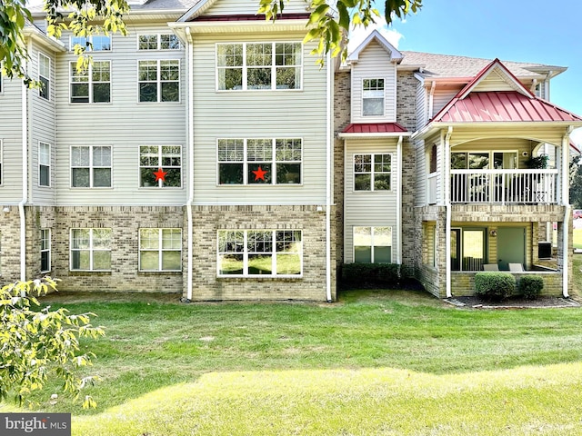 rear view of property featuring a yard