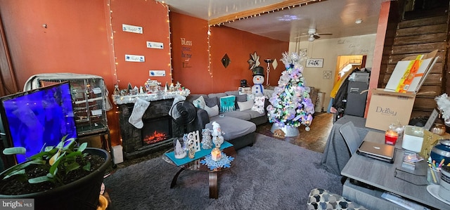 miscellaneous room with ceiling fan, carpet flooring, and a fireplace