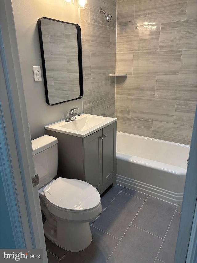 full bathroom with toilet, vanity, tile patterned flooring, and tiled shower / bath combo