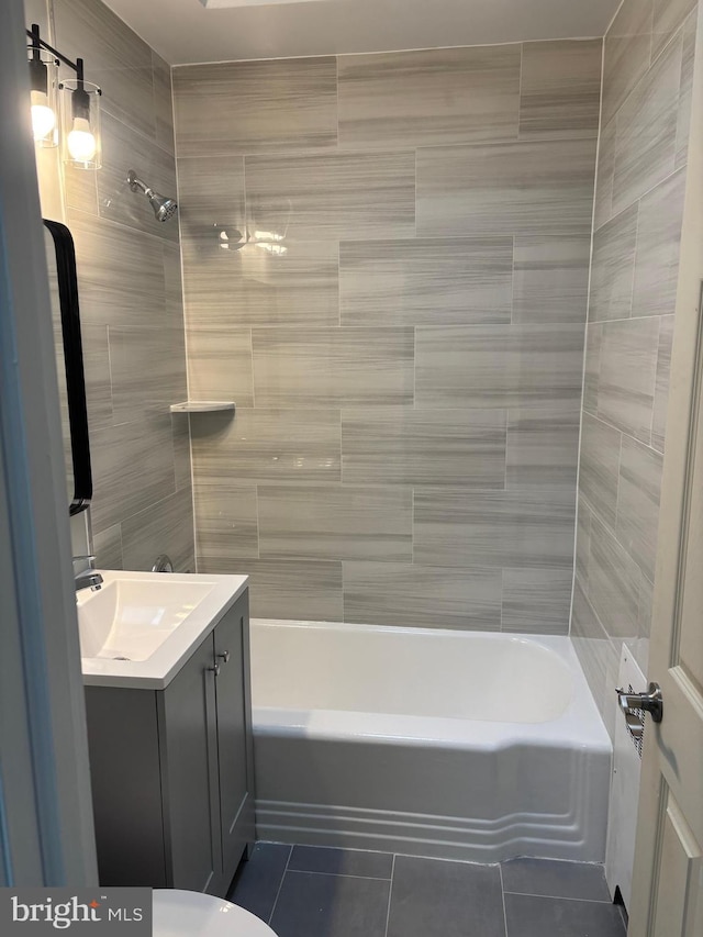 full bathroom featuring toilet, vanity, tile patterned floors, and shower / bath combination