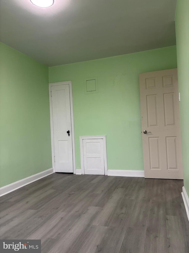 unfurnished room featuring hardwood / wood-style flooring