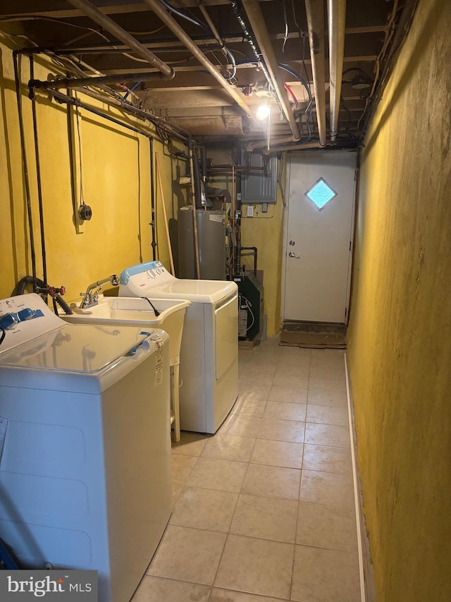 laundry area featuring water heater and washer and dryer