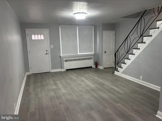 foyer with radiator heating unit and hardwood / wood-style floors