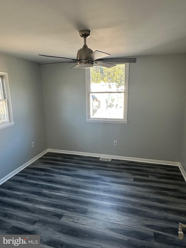 empty room featuring ceiling fan and dark wood-type flooring