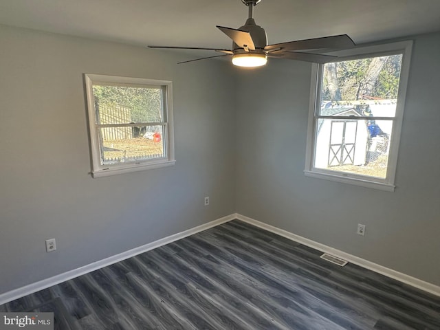 empty room featuring ceiling fan and dark wood-type flooring