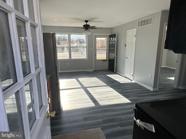 interior space with ceiling fan