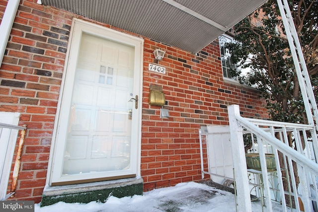 view of snow covered property entrance