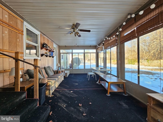 unfurnished sunroom with ceiling fan