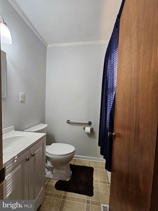 bathroom with toilet, crown molding, and vanity