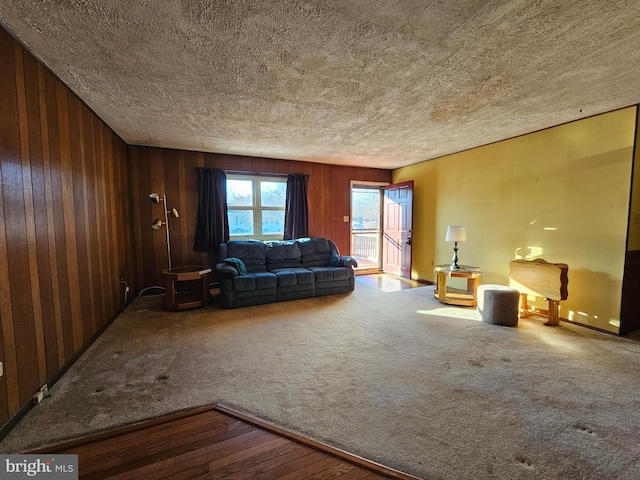 unfurnished living room featuring carpet and wooden walls