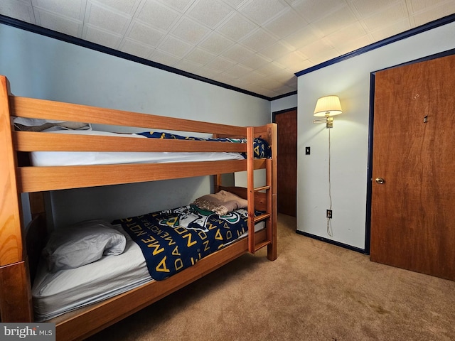 bedroom with crown molding and light carpet