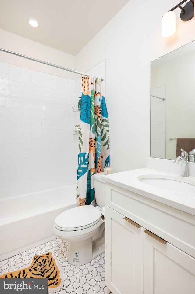 full bathroom featuring toilet, tile patterned flooring, vanity, and shower / tub combo with curtain