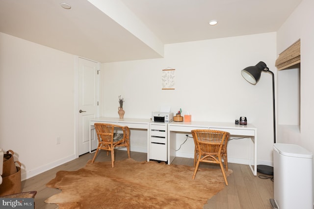 office space featuring built in desk and light hardwood / wood-style floors