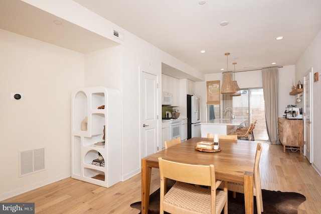 dining area featuring light hardwood / wood-style flooring and sink