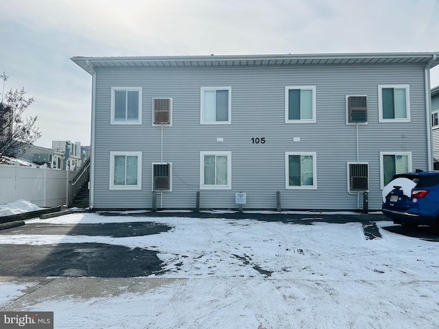 view of snow covered rear of property