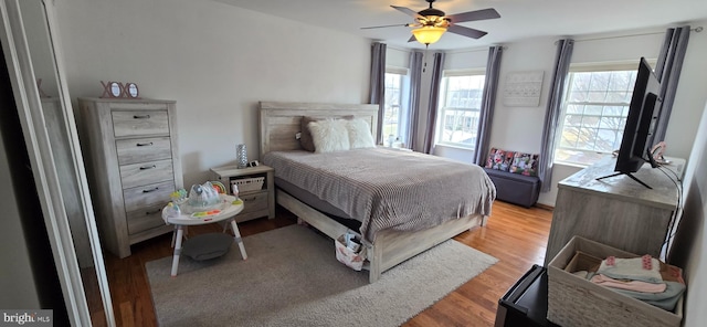 bedroom featuring light wood-type flooring and ceiling fan