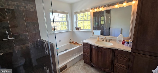 bathroom featuring vanity and independent shower and bath