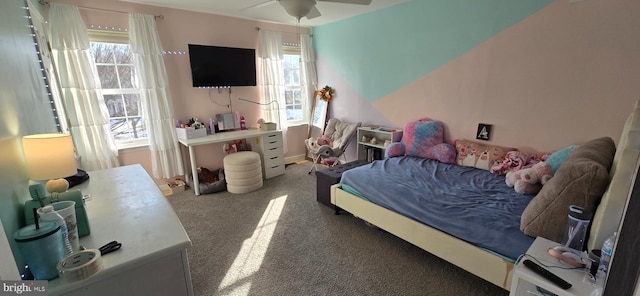 carpeted bedroom with ceiling fan and multiple windows