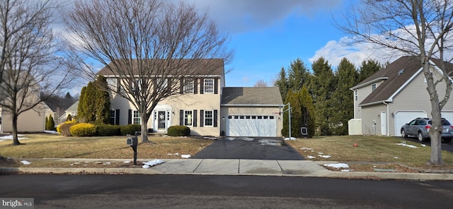 view of front of house featuring a front yard and a garage