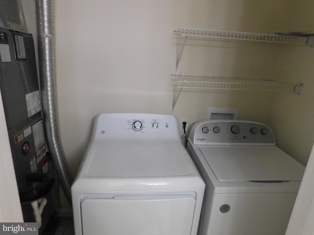 clothes washing area with laundry area and separate washer and dryer